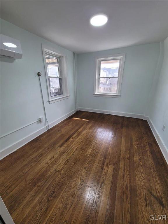 empty room with dark hardwood / wood-style floors