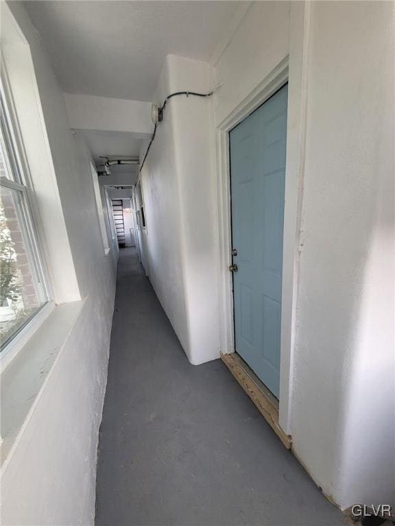 corridor with concrete flooring