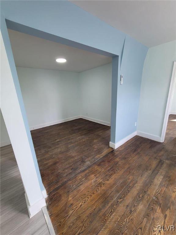 basement with dark hardwood / wood-style flooring