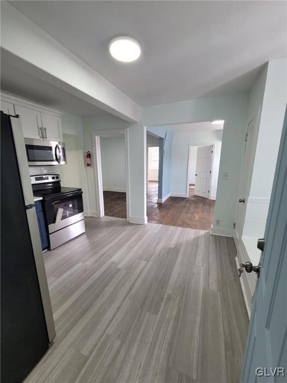 unfurnished living room with light hardwood / wood-style flooring