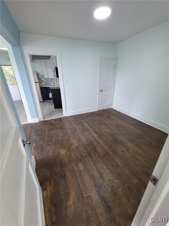 empty room featuring dark hardwood / wood-style flooring