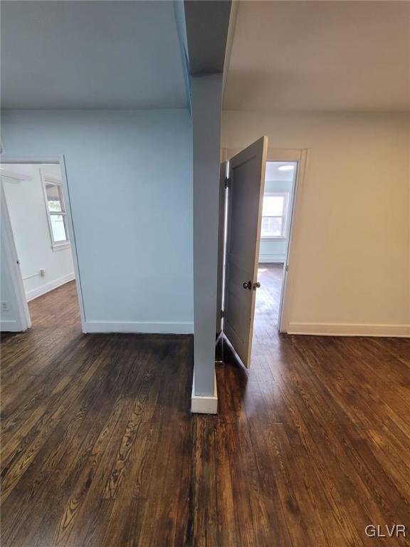 spare room with dark hardwood / wood-style flooring