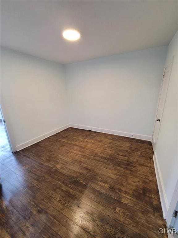 unfurnished room featuring dark hardwood / wood-style flooring