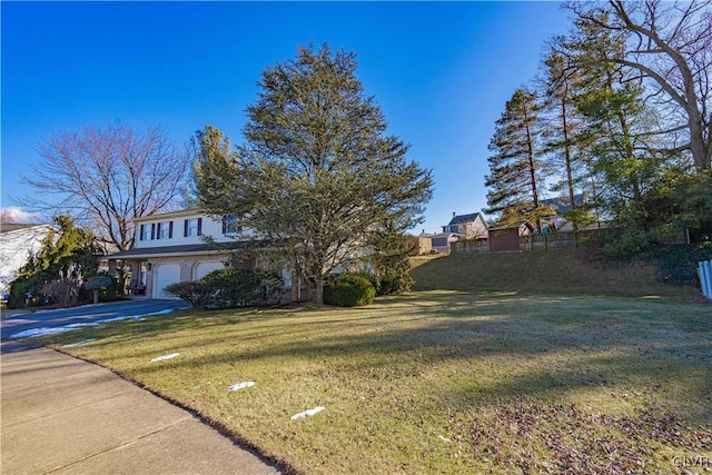 view of front of property with a front yard and a garage