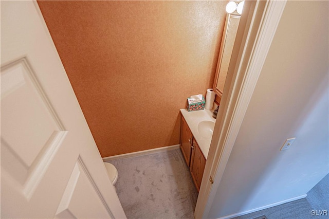 bathroom featuring toilet and vanity