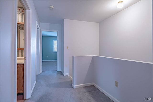 hallway with light colored carpet