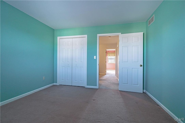 unfurnished bedroom with carpet and a closet