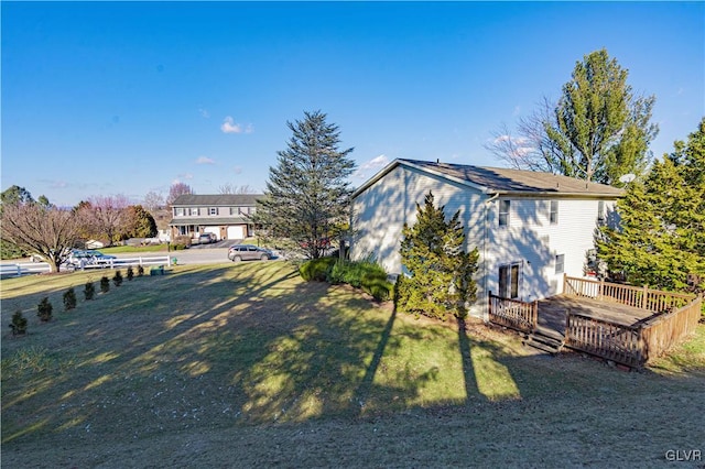 exterior space with a front yard and a wooden deck