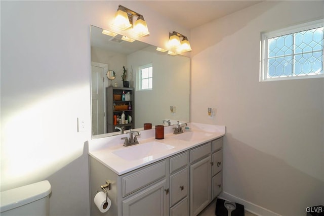 bathroom featuring toilet and vanity