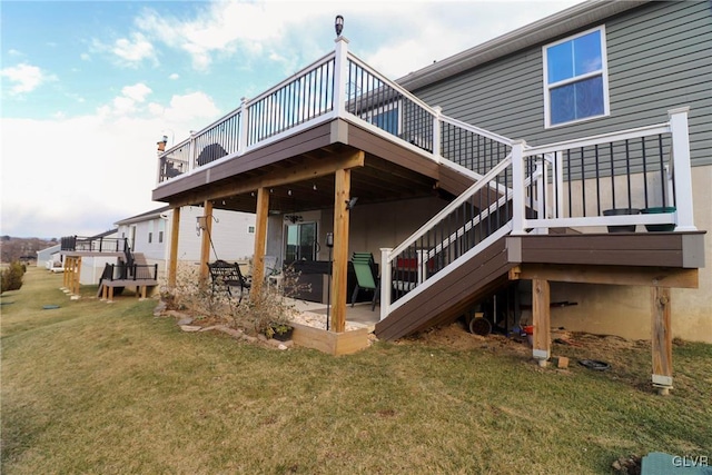 rear view of house with a yard and a wooden deck