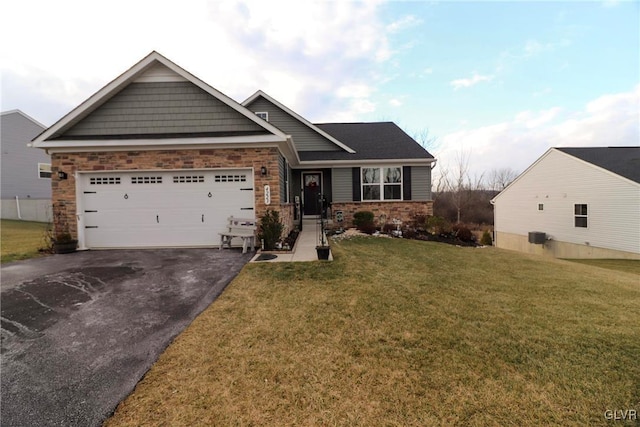 view of front of home with a front lawn and a garage