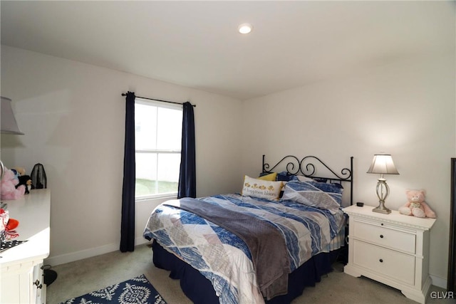 bedroom featuring light carpet