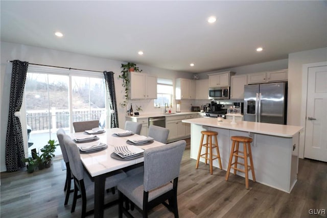 dining room featuring sink and dark hardwood / wood-style floors