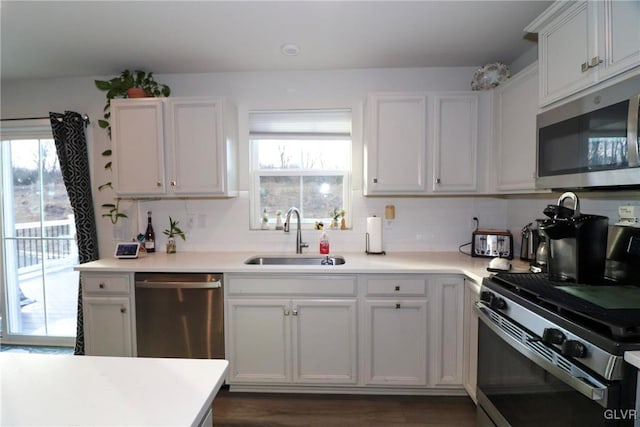 kitchen featuring sink, white cabinets, and appliances with stainless steel finishes