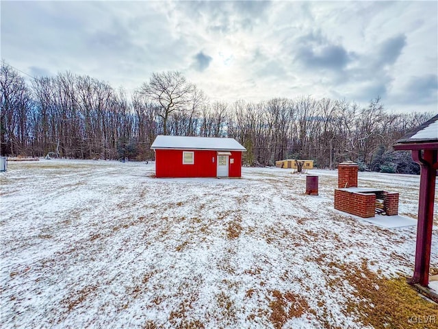 yard covered in snow with an outdoor structure