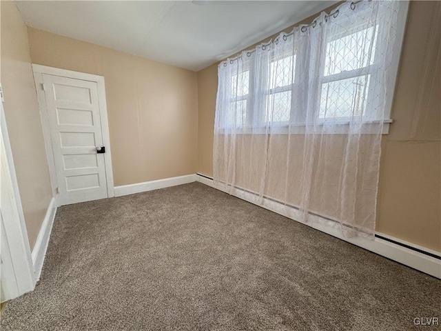 empty room with baseboard heating and carpet floors