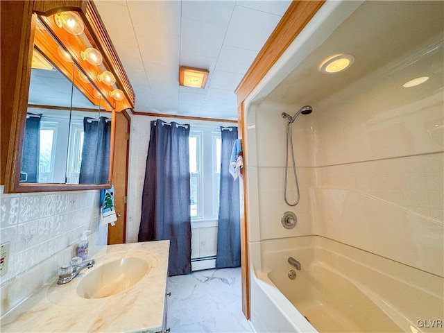 bathroom with a baseboard radiator, vanity, decorative backsplash, shower / bathtub combination, and crown molding