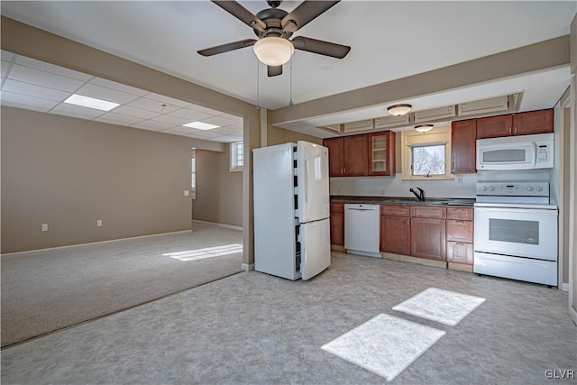 kitchen with light carpet, ceiling fan, white appliances, a paneled ceiling, and sink