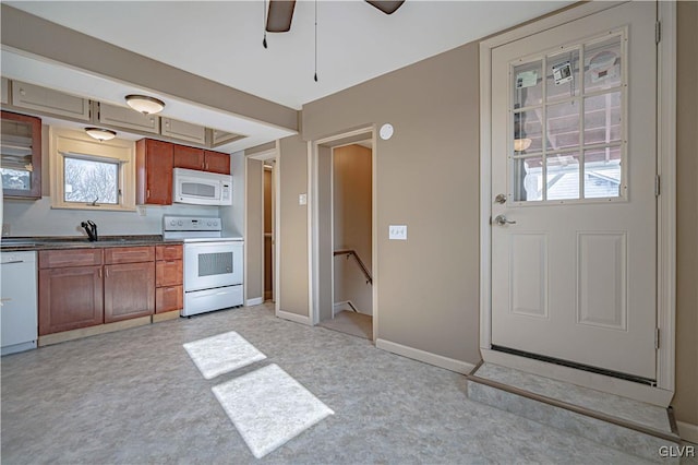 kitchen featuring ceiling fan, light colored carpet, sink, and white appliances