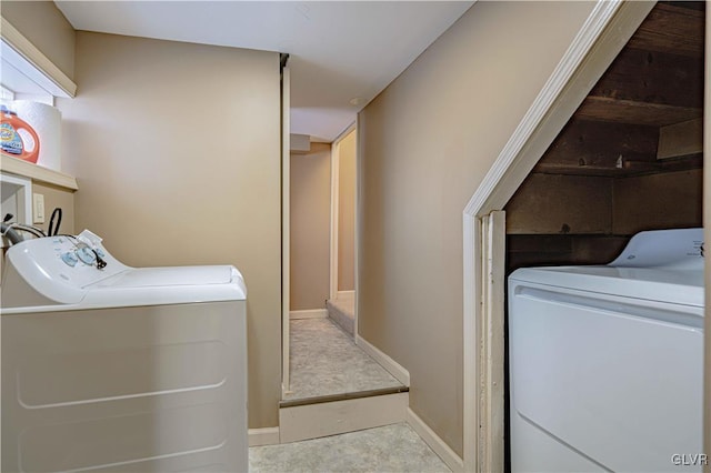 clothes washing area with washer and clothes dryer