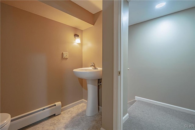 bathroom with toilet and a baseboard radiator