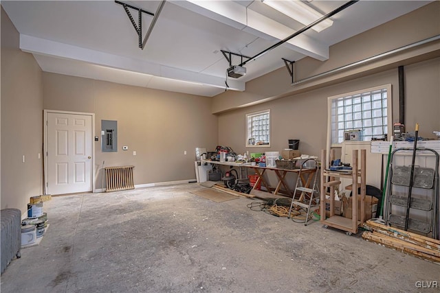 garage with a garage door opener and electric panel