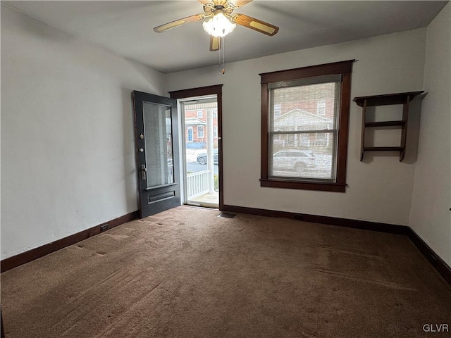 carpeted entrance foyer with ceiling fan