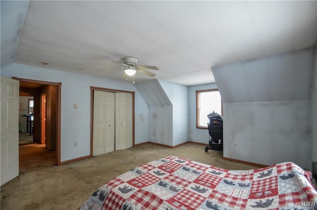 carpeted bedroom with ceiling fan, a closet, and lofted ceiling