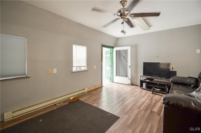 living room featuring ceiling fan, wood-type flooring, and a baseboard heating unit