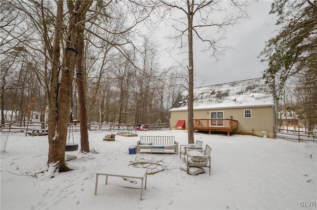 yard covered in snow featuring a wooden deck