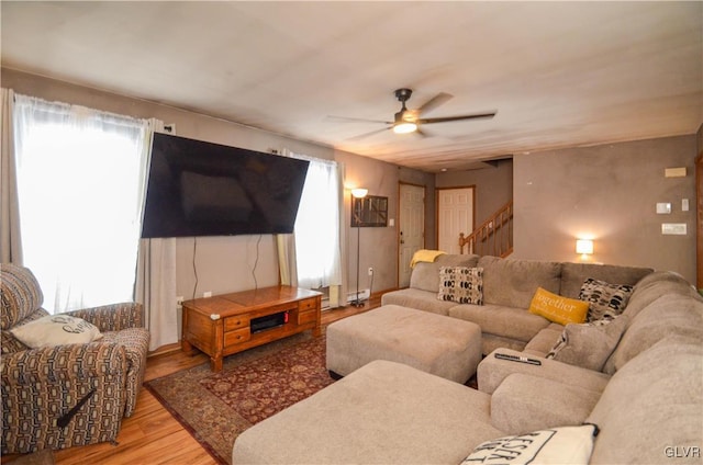 living room featuring ceiling fan and light hardwood / wood-style flooring