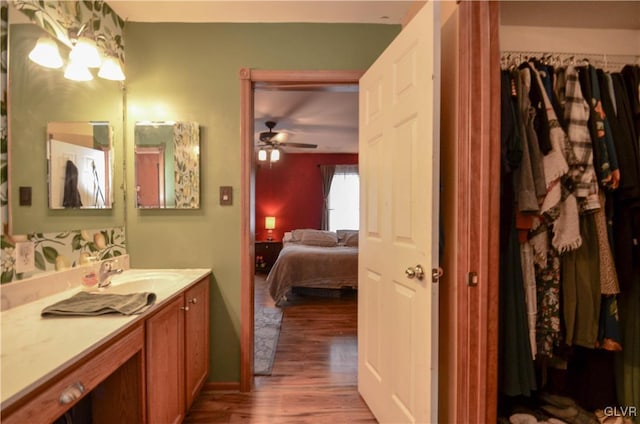 bathroom with ceiling fan, hardwood / wood-style flooring, and vanity