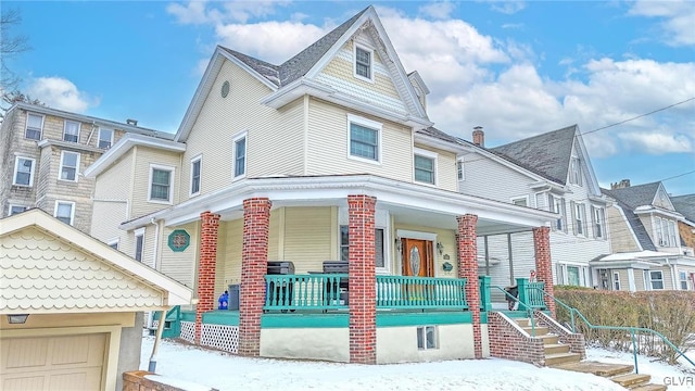 view of front facade featuring covered porch and a garage