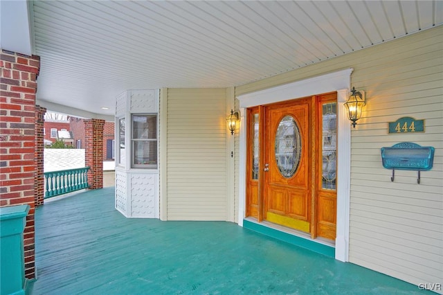 view of exterior entry with covered porch