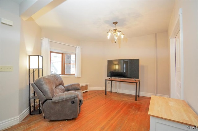 living room featuring hardwood / wood-style floors and a notable chandelier