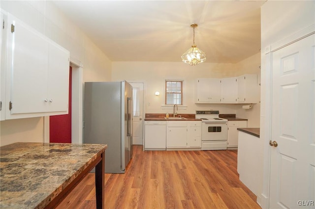 kitchen with light hardwood / wood-style floors, sink, white appliances, white cabinetry, and hanging light fixtures