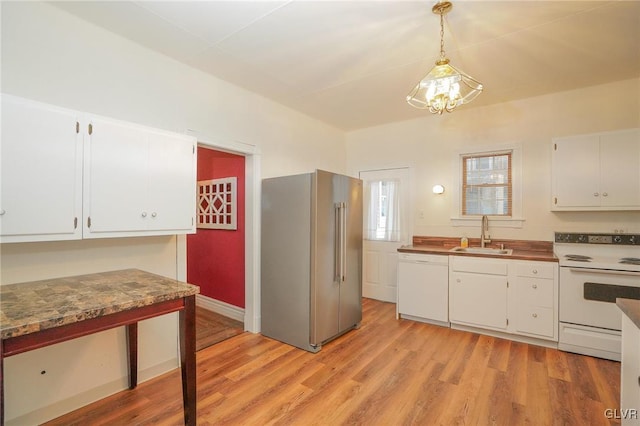 kitchen with white cabinetry, light hardwood / wood-style floors, white appliances, pendant lighting, and sink