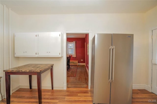 corridor with light hardwood / wood-style floors