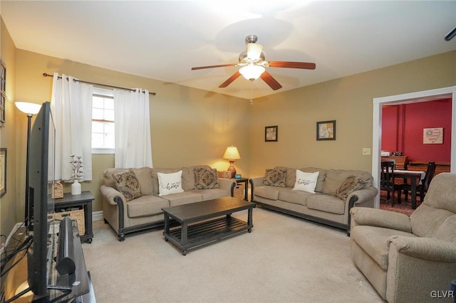 carpeted living room featuring ceiling fan