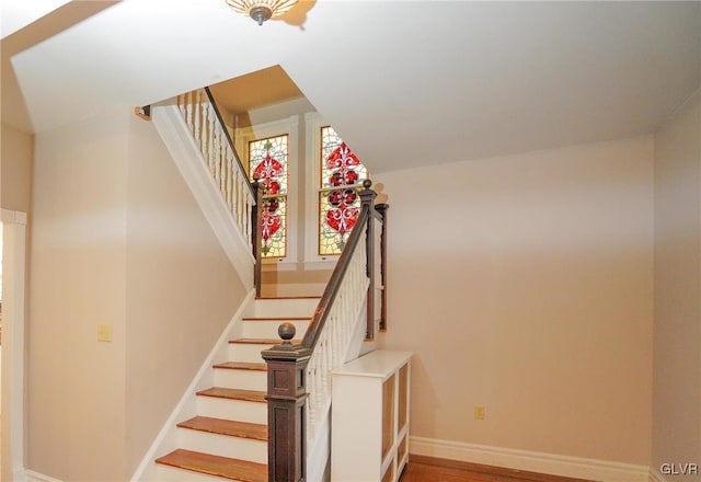 stairway with hardwood / wood-style flooring