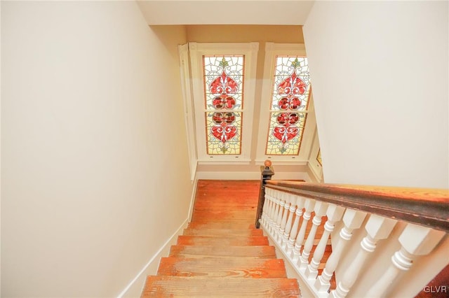 staircase featuring wood-type flooring