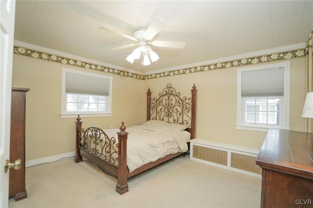 carpeted bedroom with ceiling fan, crown molding, and radiator heating unit