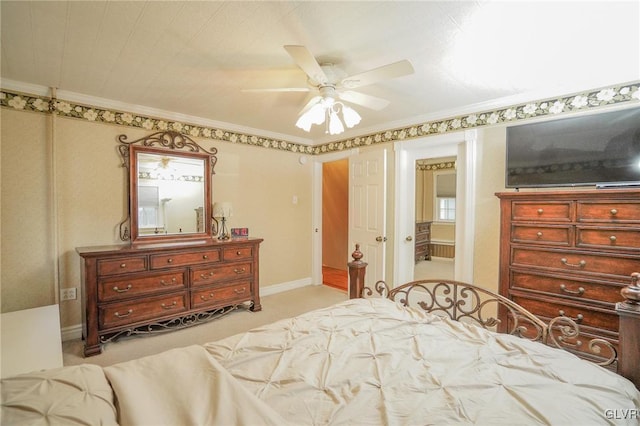 bedroom featuring ceiling fan, crown molding, and light colored carpet