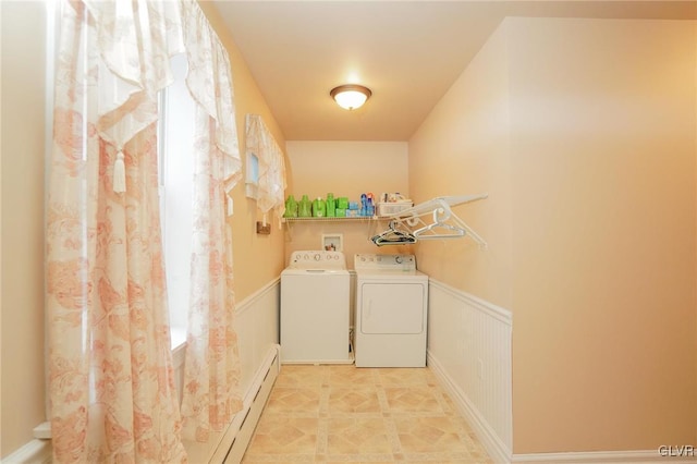 washroom featuring a baseboard heating unit and washer and dryer