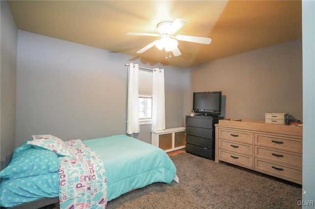 bedroom featuring ceiling fan and dark carpet