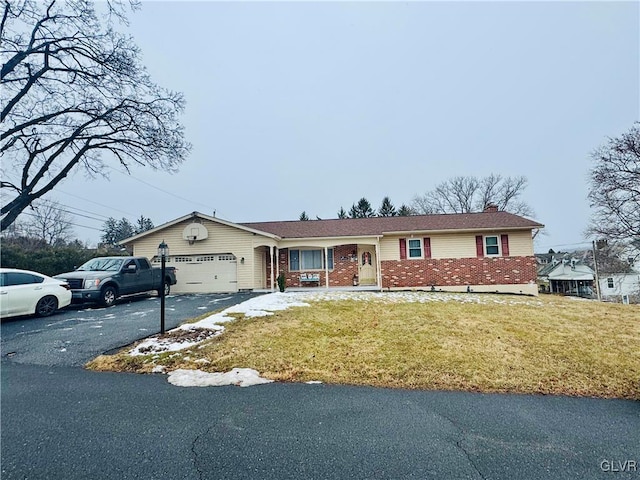 single story home with a garage and a front lawn