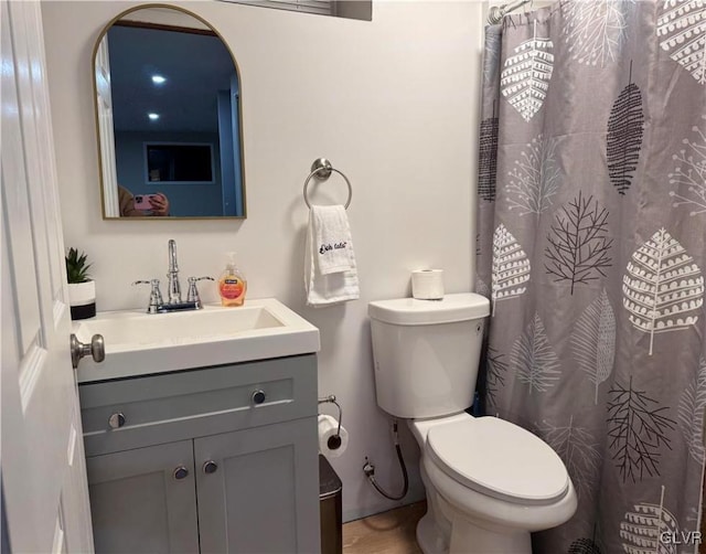 bathroom featuring toilet and vanity