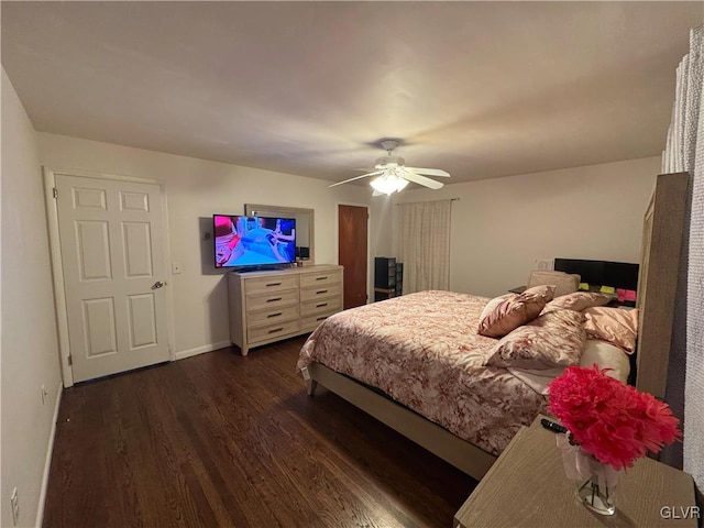 bedroom with ceiling fan and dark hardwood / wood-style floors