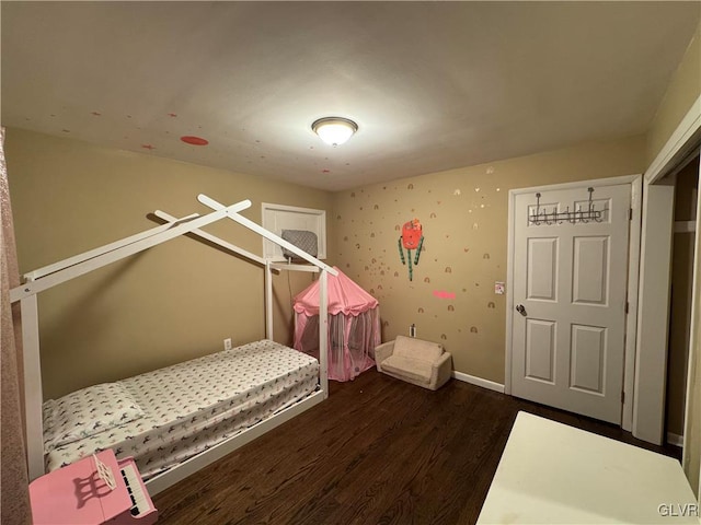 bedroom with dark hardwood / wood-style flooring