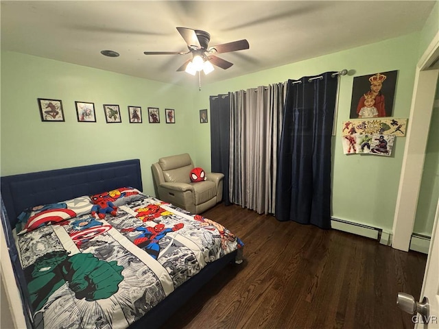 bedroom with ceiling fan, a baseboard heating unit, and dark hardwood / wood-style floors